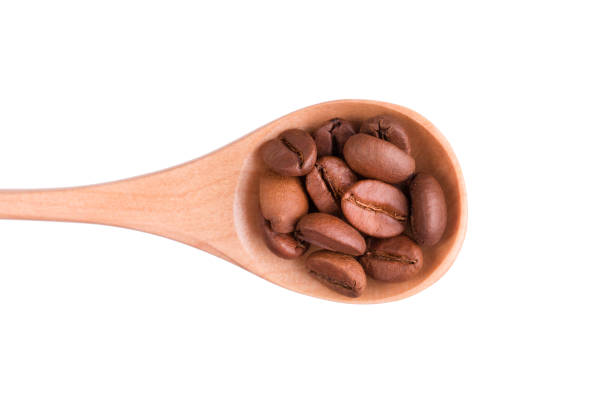 istock Grains of coffee in a spoon on a white background 928005702