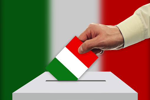 Man voting on elections in Italy front of flag