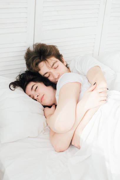 istock Couple in love sleeps cuddling in bed 928005928