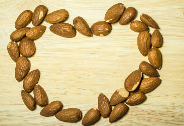 istock Almonds are arranged heart frame on a wooden table 928010014