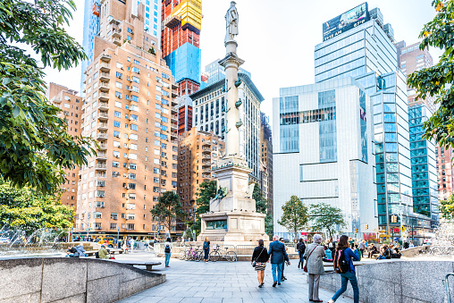 New York City, USA - October 28, 2017: Christopher Columbus Circle in Midtown Manhattan with statue, skyscrapers, construction, people walking, fountain on sunny day