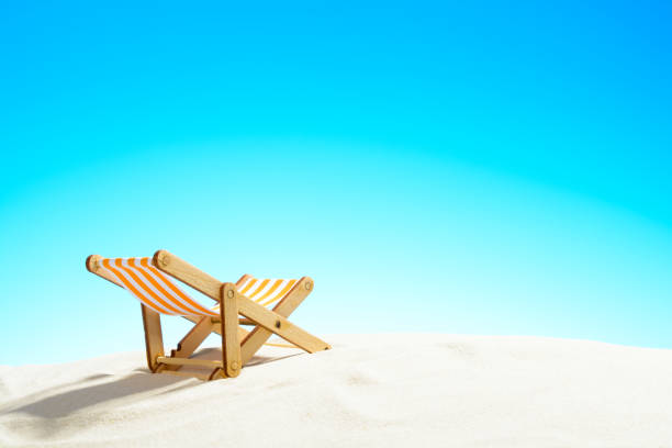 istock Sun lounger on the sandy beach and sky with copy space 928014120