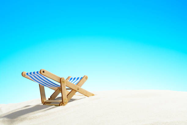 istock Sun lounger on the sandy beach and sky with copy space 928014128
