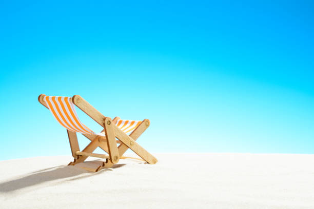 istock Sun lounger on the sandy beach and sky with copy space 928014142