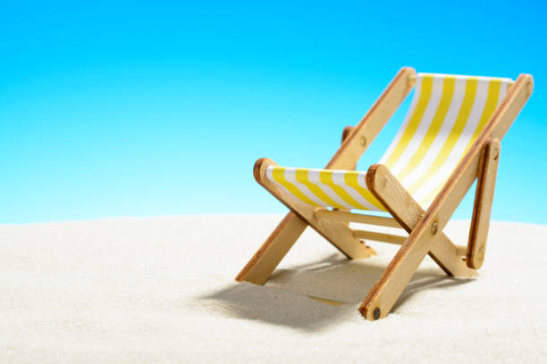 istock Sun lounger on the sandy beach and sky with copy space 928014152