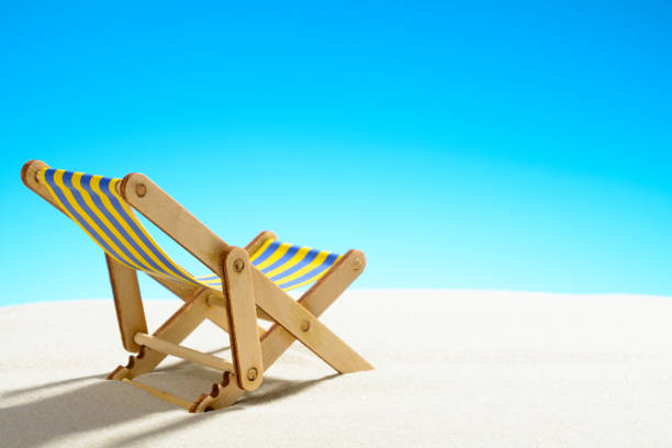 istock Sun lounger on the sandy beach and sky with copy space 928014172