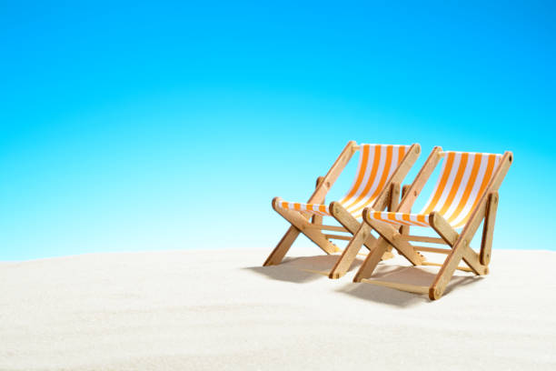 istock Two sun loungers on the sandy beach and the sky with copy space 928014180