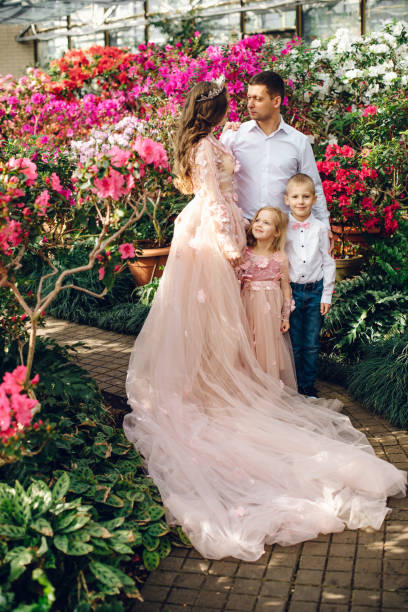 istock Young happy family in a blooming spring garden 928016954