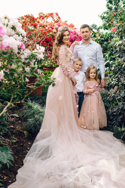 istock Young happy family in a blooming spring garden 928016992
