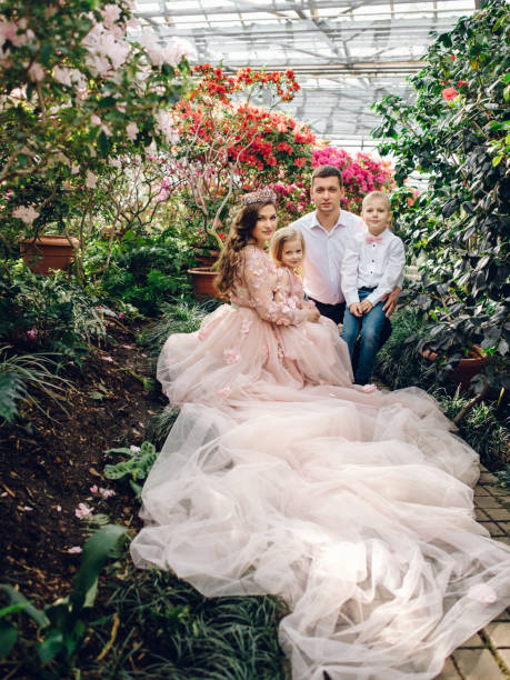 istock Young happy family in a blooming spring garden 928017022