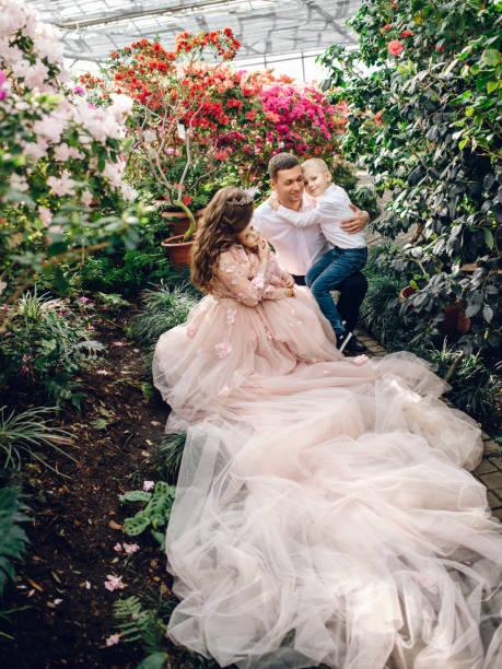 istock Young happy family in a blooming spring garden 928017112