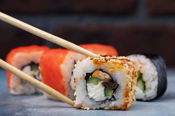 istock Rolls Unagi maki with cucumber, eel and sesame. Japanese restaurant menu with space for text 928017658