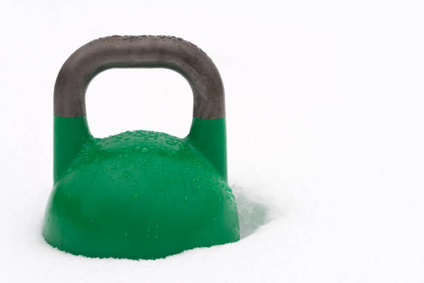 istock Green weight training kettlebell covered with water droplets outside in the snow 928020584