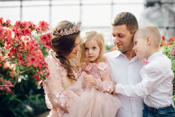istock Young happy family in a blooming spring garden 928020688