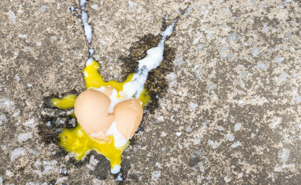 istock Soft boiled egg broken on the floor., copy space for text., food expired concept. sad concept. food concept. 928021418