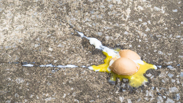istock Soft boiled egg broken on the floor., copy space for text., food expired concept. sad concept. food concept. 928021424