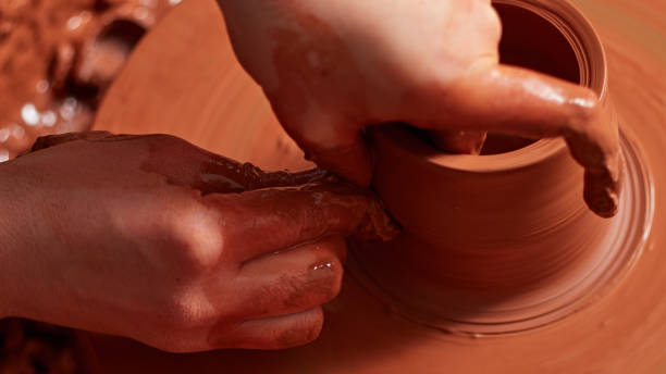istock production process of pottery. Forming a clay teapot on a potter's wheel. 928021614
