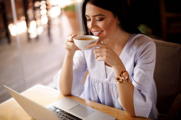 istock Woman enjoying tea at a cafe 928024372