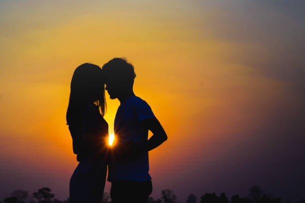 istock romantic couple hugging at colorful sunset. 928024644