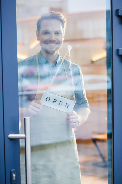 istock Happy friendly man opening the cafe 928027718