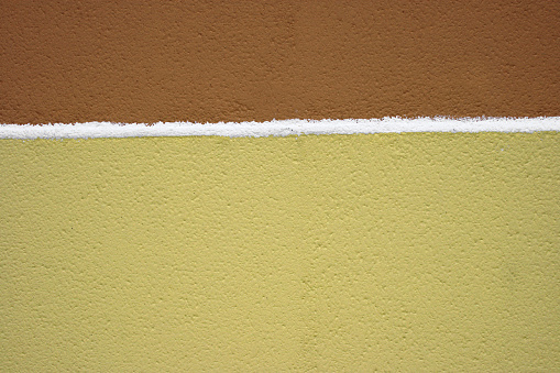Brown and yellow wall with white line. More yellow walls: