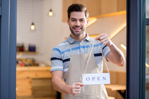 istock Happy friendly man inviting to his cafe 928029052