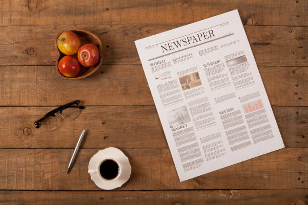 istock newspaper over wooden table 928036124