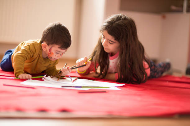 istock Kids painting with watercolor paints 928037332