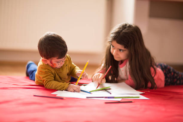 istock Kids painting with watercolor paints 928040392