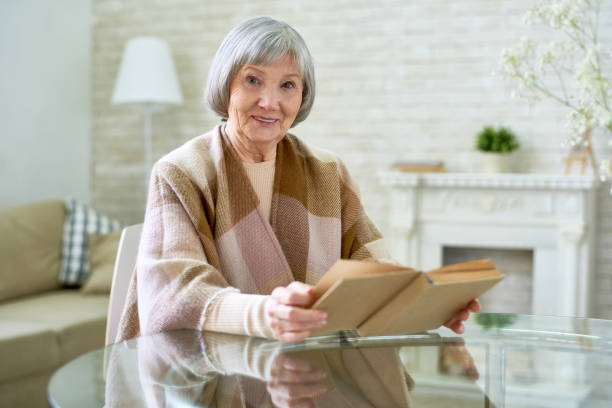istock Elegant Senior Lady Reading Book 928044318