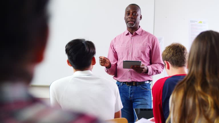 Male College Tutor With Digital Tablet Teaching Class