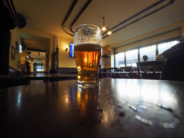 a pint of British ale beer in a pub selective focus on glass
