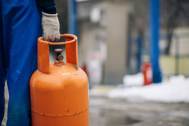 istock Man carrying LPG gas bottle 928047966
