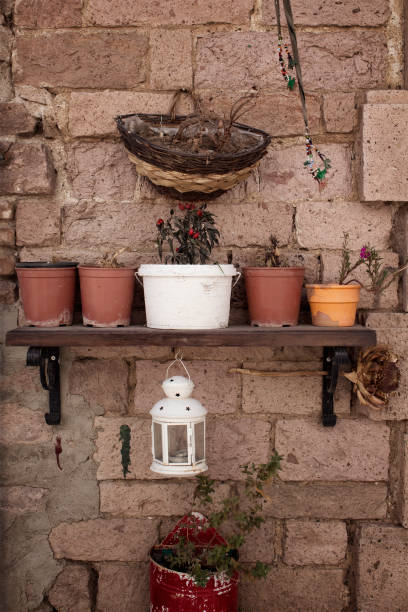 istock View of decorative objects and flower pots on stone wall in Cunda (Alibey) island. 928048030