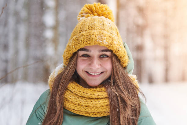istock Beautiful young girl in knitted hat on winter forest background 928048218