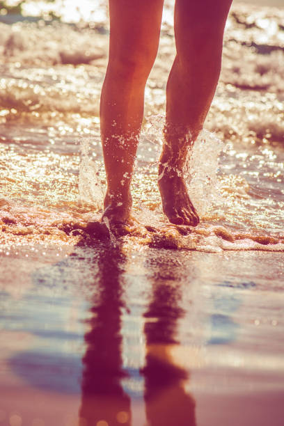 istock Girl running in the sea 928048292