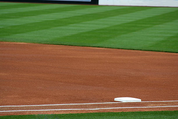 A close-up shot of first base and the out field stock photo