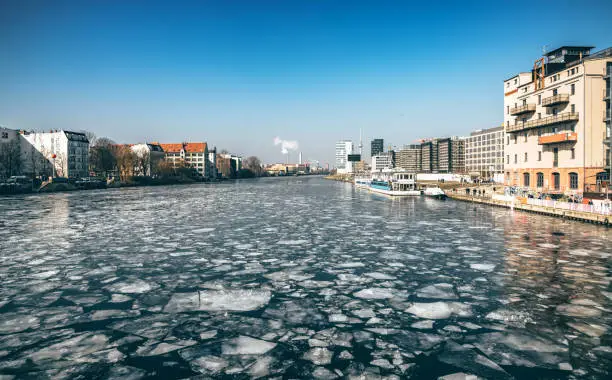 Berlin skyline with Television tower over frozen river in Berlin