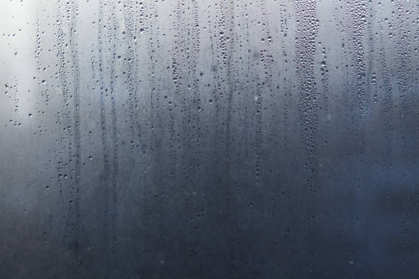 istock Flowing down water drops on window glass 928054466