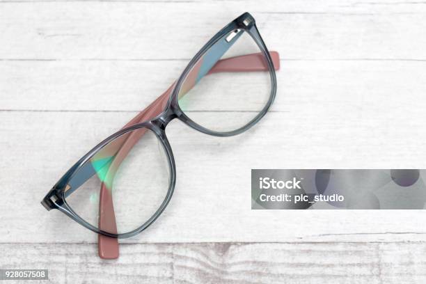 Eye Glasses On Wooden Table Stock Photo - Download Image Now - Eyeglasses, Arts Culture and Entertainment, Black Color