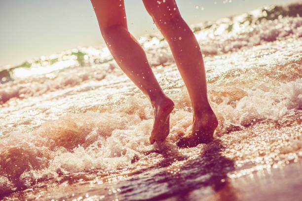 istock Girl running in the sea 928058198