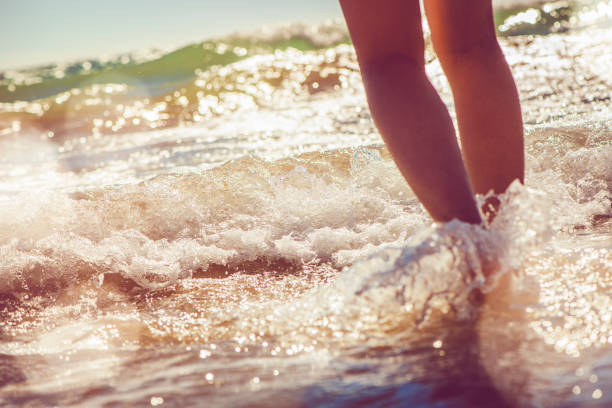 istock Girl standing in the sea 928058300