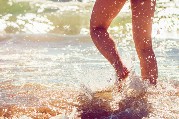 istock Girl running in the sea 928058374