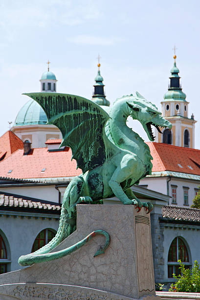 istock A green dragon statue perched atop a concrete platform 92806075