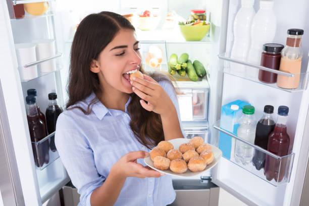 istock Smiling Woman Eating Cookies In Plate 928066116