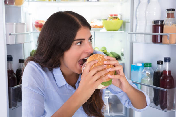 istock Happy Woman Eating Burger 928066166