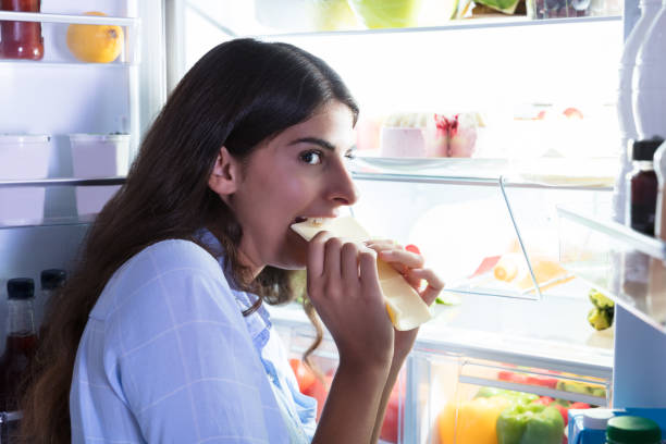 istock Woman Eating Slice Of Cheese 928066180