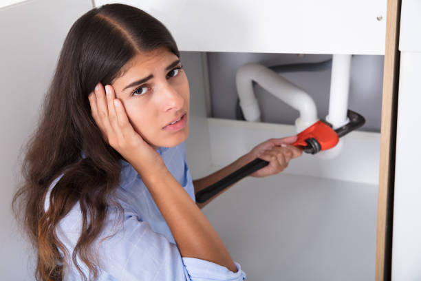 istock Woman Holding Head While Tightening Sink Pipe 928066314