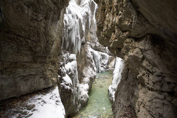 istock Frozen waterfall with icicles seen in the parkFrozen waterfall with icicles seen in the park 928068618