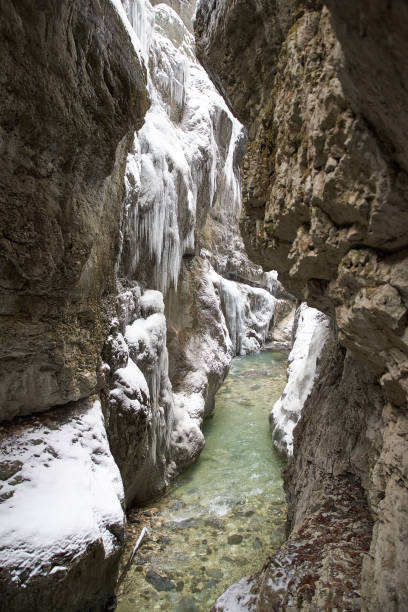 istock Frozen waterfall with icicles seen in the parkFrozen waterfall with icicles seen in the park 928068628